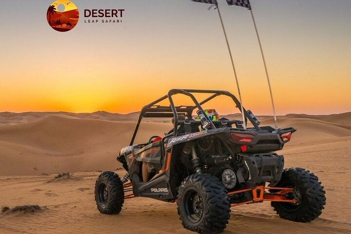 Feel the rush as you navigate the endless golden dunes in a Dune Buggy capturing the essence of adventure against a backdrop of Dubai's mesmerizing desert sunset. Unforgettable moments await!